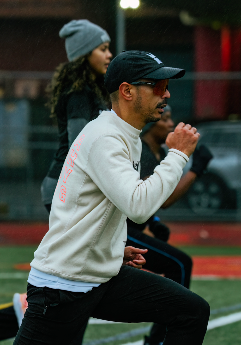 Coach showing althete how to perform running drill