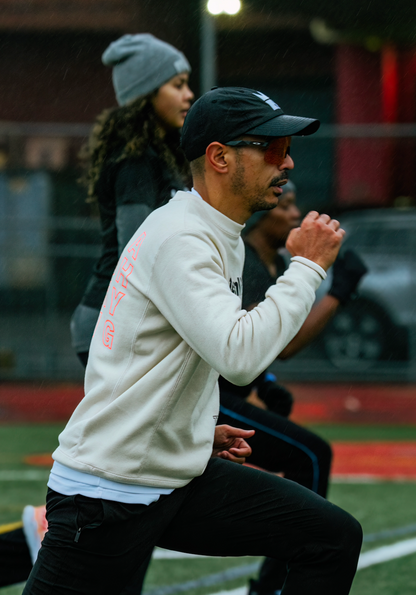 Coach showing althete how to perform running drill